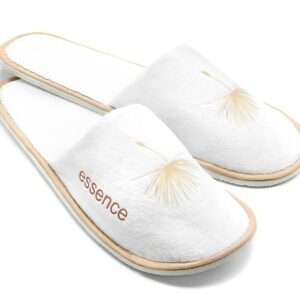 A pair of Essence hotel slippers, white color. A premium part of the ESSENCE hotel toiletries collection, natural and indulgent hotel amenities.