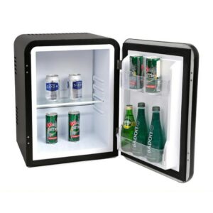 Hotel room minibar fridge, 30 liters, black color, vintage retro style, stocked with soft drinks, and water bottles. A luxury hotel room appliance for guest comfort and convenient access to refreshments, enhancing overall hotel amenities.