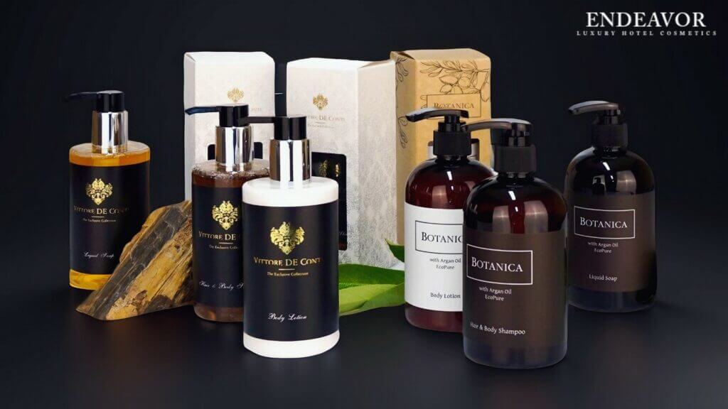 A set of hotel toiletries in refillable dispenser bottles with shampoo, liquid soap, conditioner, body lotion