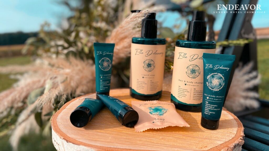 Hotel toiletries brand Ella Delannoy, four sleek green tubes, a soap in paper bag, and two pump bottles, formulated with argan oil, and Eco pure. A premium part of the ELLA DELANNOY natural and vegan hotel toiletries collection.