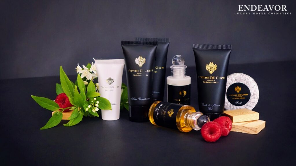 Elegant display of luxury hotel toiletries brand Vittore De Conti. Mini bottles of shampoo, conditioner, a soap bar wrapped in paper and shower gel, body wash, body lotion, hair conditioner in mini tubes.